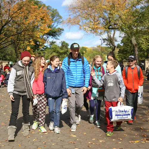 Students walking alongside their guide on an educational tour in New York City.